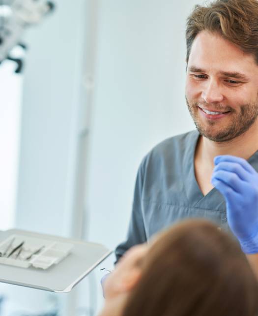 male-dentist-and-woman-in-dentist-office-2025-01-08-14-25-52-utc